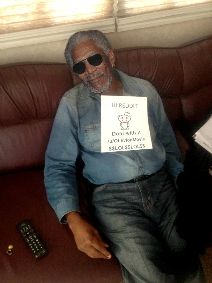Morgan Freeman with sunglasses holding a 'Deal with it' Reddit AMA sign