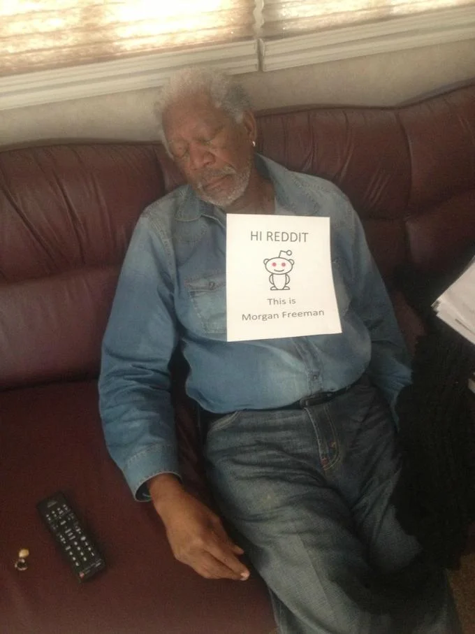 Morgan Freeman with a 'Hi Reddit' sign on his chest, promoting an AMA