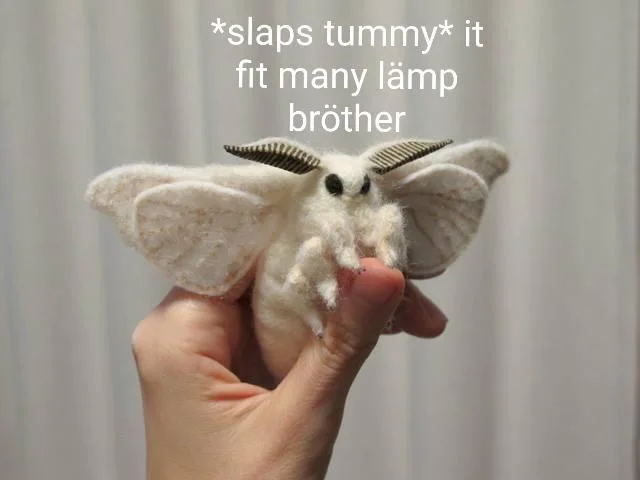 Moth Lamp — Fuzzy moth held in hand with stylized text 'slaps tummy it fit many lämp brother'.
