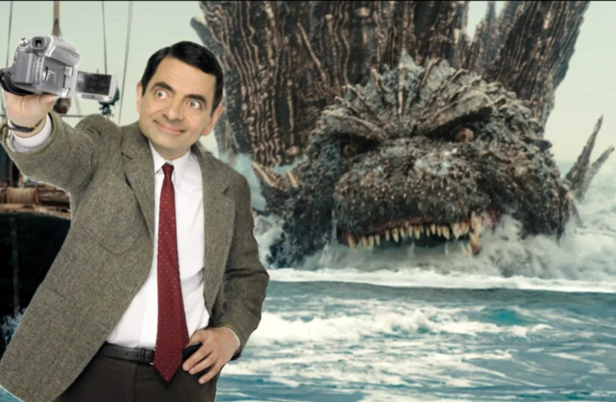 Mr. Bean holding Teddy while Godzilla towers over him