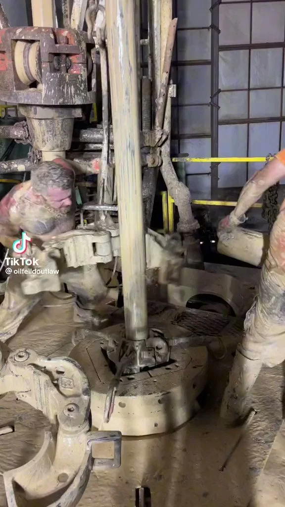 Muddy Workers Operating Machinery