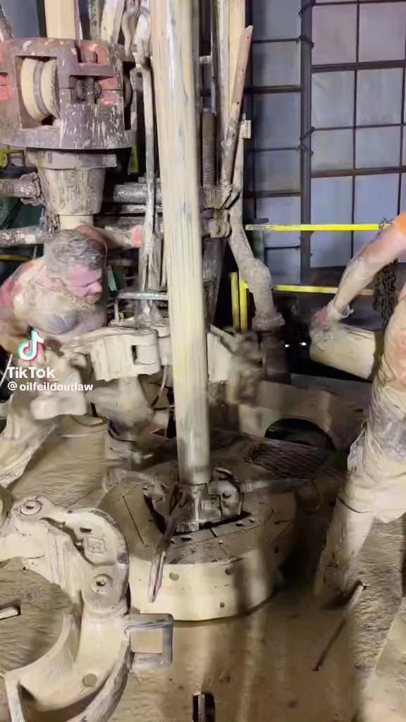 Muddy Workers Operating Machinery