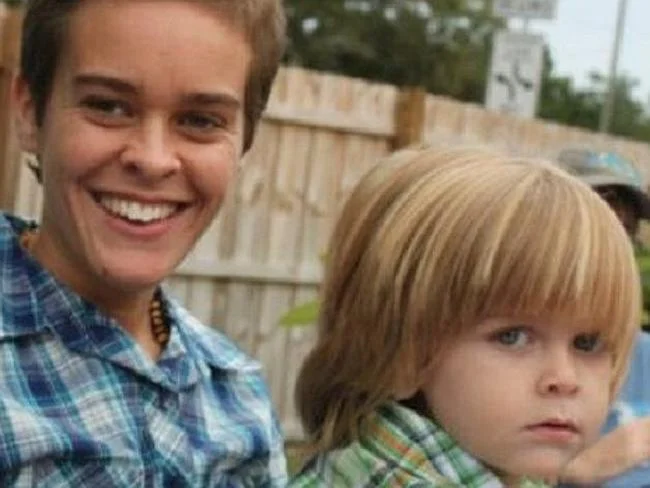 Munchausen By Internet — Photo of a short-haired woman smiling beside a young blond child outdoors