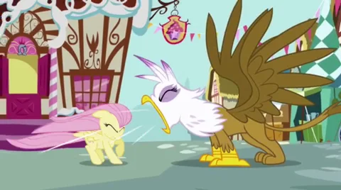 My Little Pony Character Fandom — Screenshot of timid Fluttershy cowering as aggressive griffin Gilda looms over her.