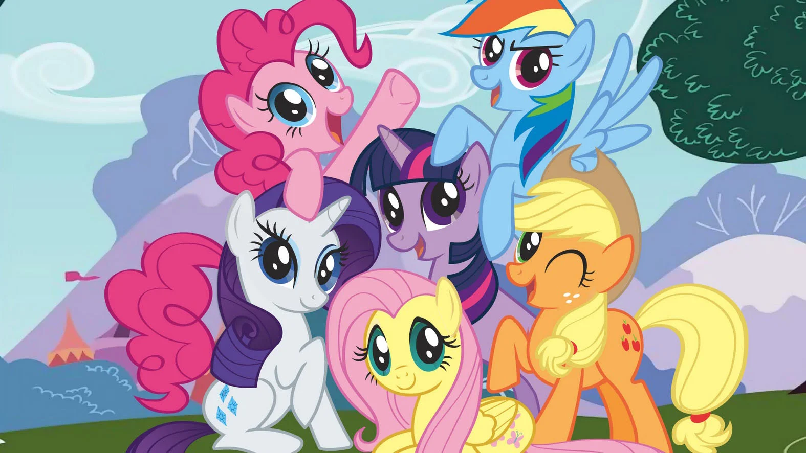 The Mane Six ponies from My Little Pony: Friendship is Magic posed together outdoors.