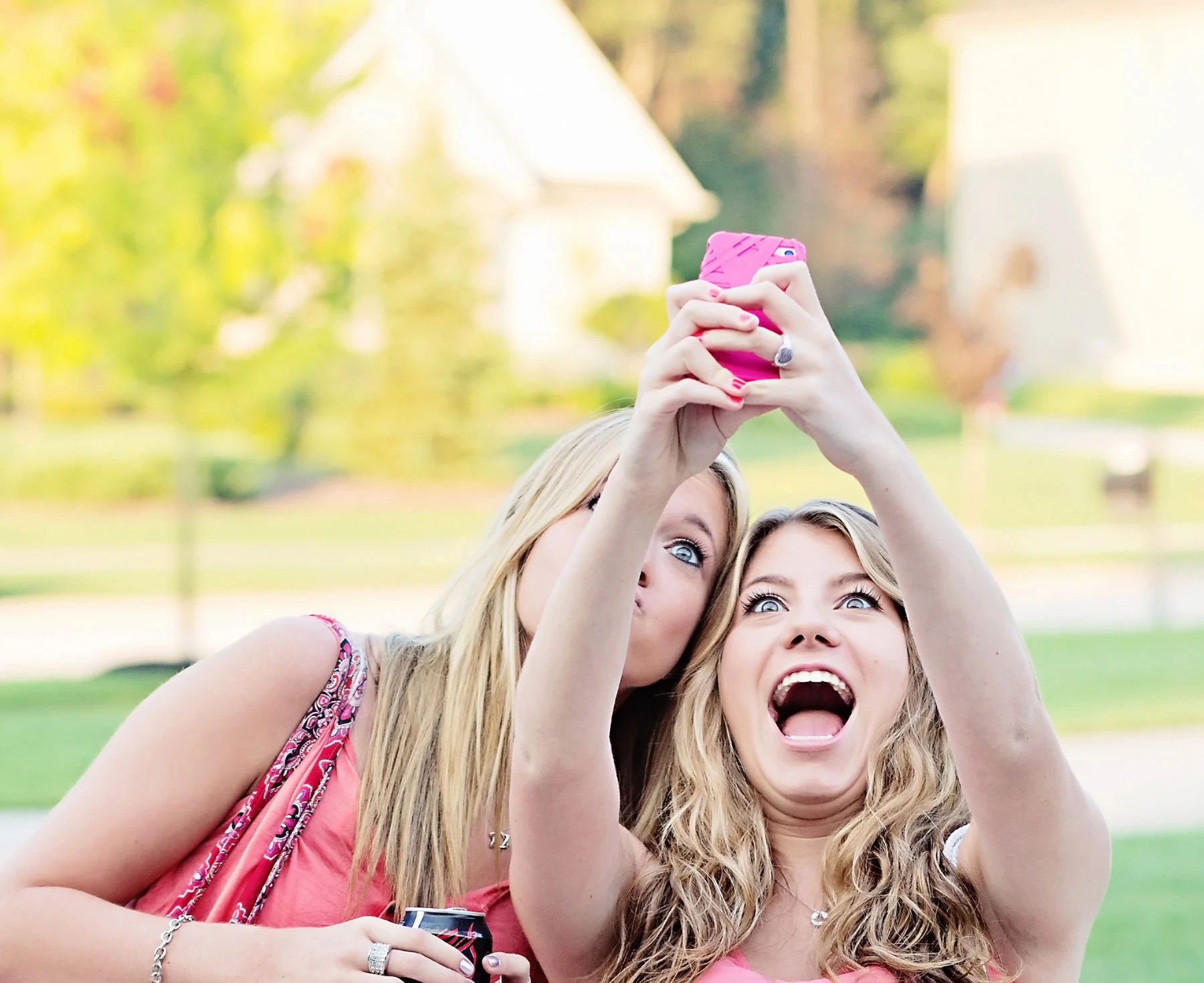 MySpace Angles — Two teenage girls taking a high-angle selfie with a pink phone outdoors