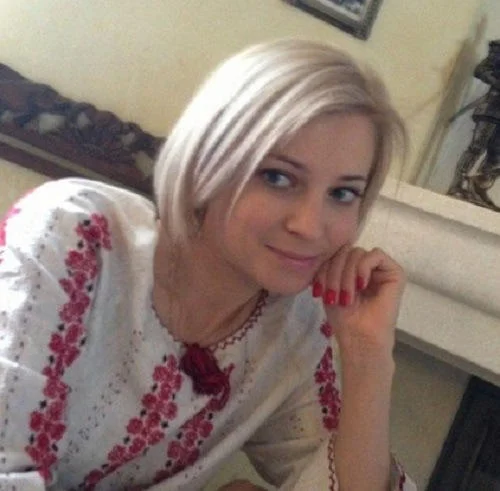 Young Natalia Poklonskaya smiling in a traditional embroidered blouse