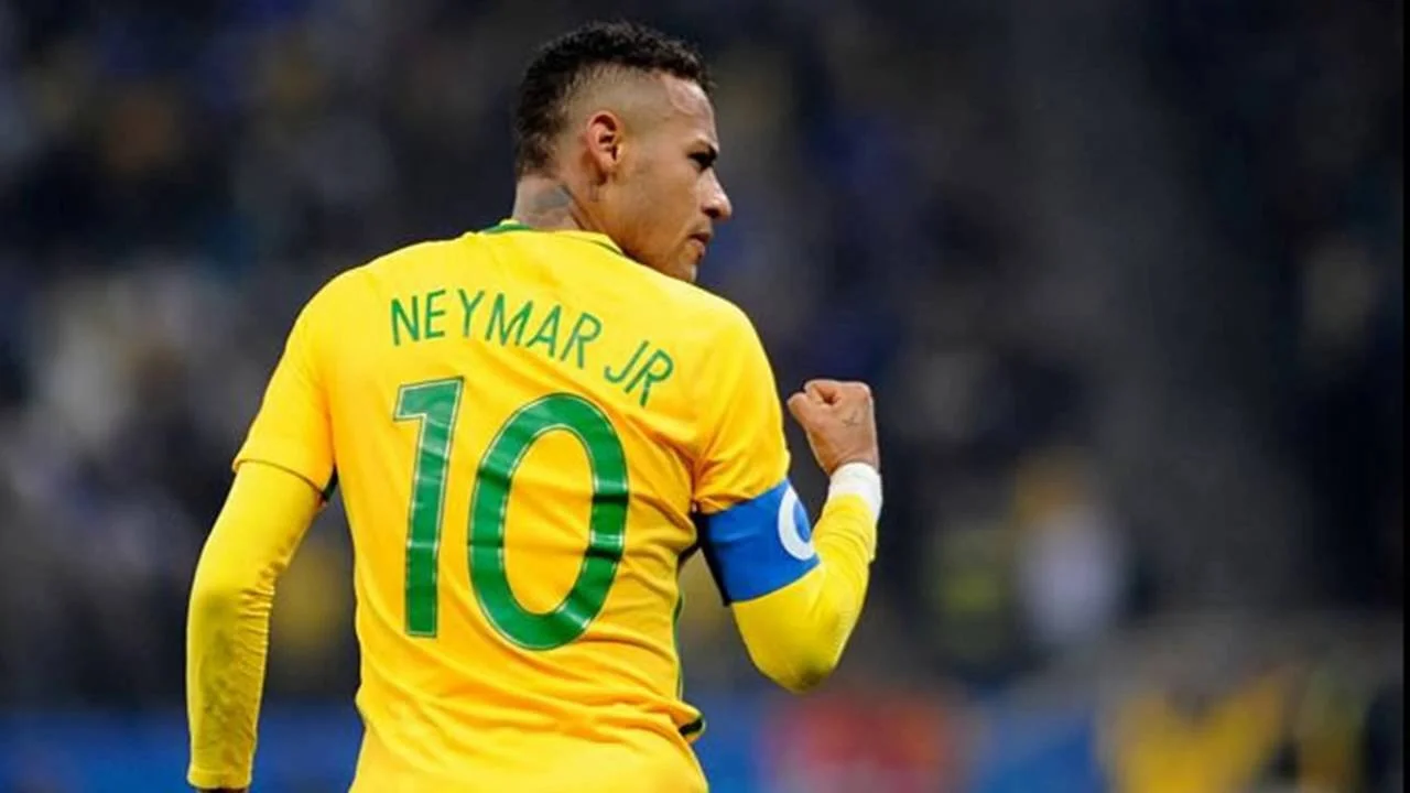 Neymar Jr. in yellow Brazil jersey number 10 celebrating with clenched fist