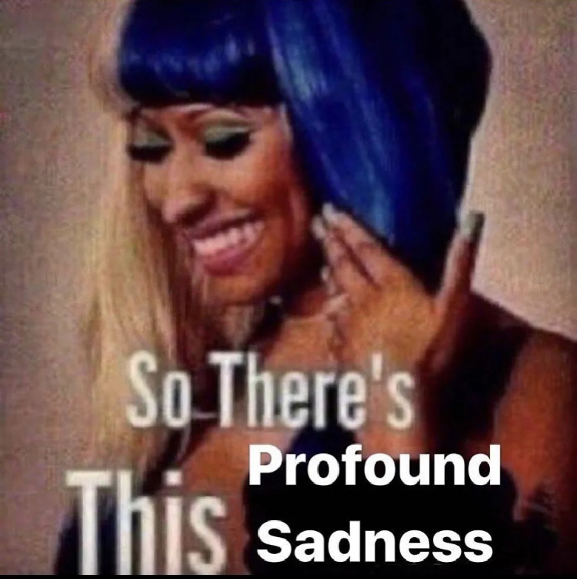 Nicki Minaj laughing in blue wig with So there's this profound sadness caption