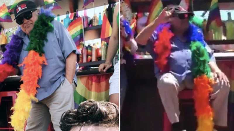 No Cops At Pride — Two side-by-side photos of Danny DeVito wearing vibrant rainbow feather boas at a Pride event.