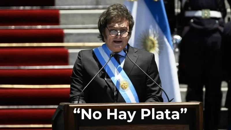 No Hay Plata — Javier Milei stands at a podium during his presidential address wearing the blue and white presidential sash.
