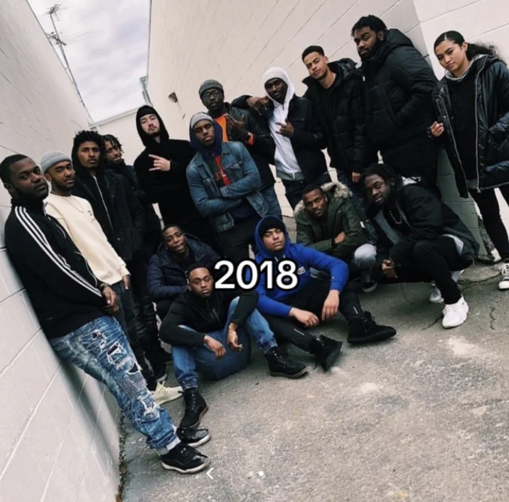 Noah Boat N Em — Large group of friends posing in an alleyway in 2018 as part of Noah's annual crew photo.