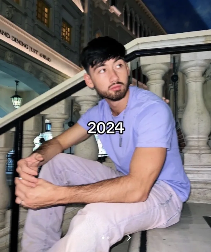 Noah Boat N Em — Adult Noah in a lavender t-shirt sitting on ornate stone stairs at a Venetian-style resort in 2024.