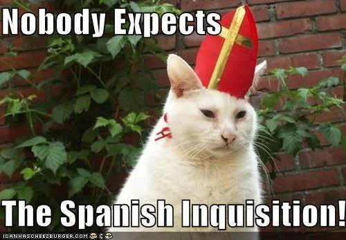 Nobody Expects the Spanish Inquisition — White cat wearing red Spanish inquisition hat with 'Nobody Expects' and 'The Spanish Inquisition!' text.