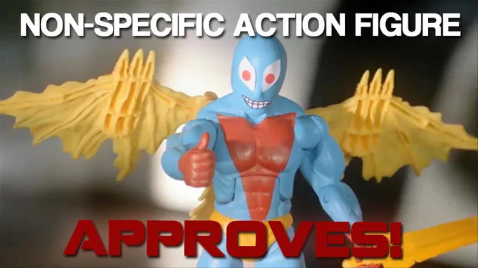 Non Specific Action Figure — Close-up of blue Non-Specific Action Figure with yellow wings and red eyes giving thumbs-up with 'APPROVES!' text.