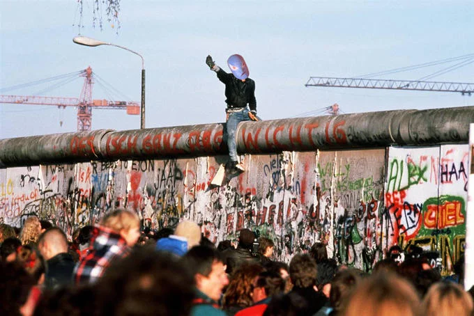 Non Specific Action Figure — Person on Berlin Wall with Non-Specific Action Figure's head photoshopped in historical moment.