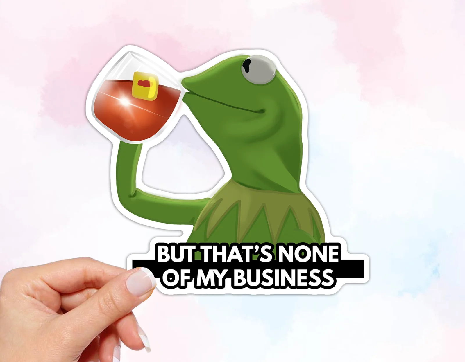 Kermit None of My Business — Die-cut sticker of Kermit holding cocktail with 'BUT THAT'S NONE OF MY BUSINESS' text.