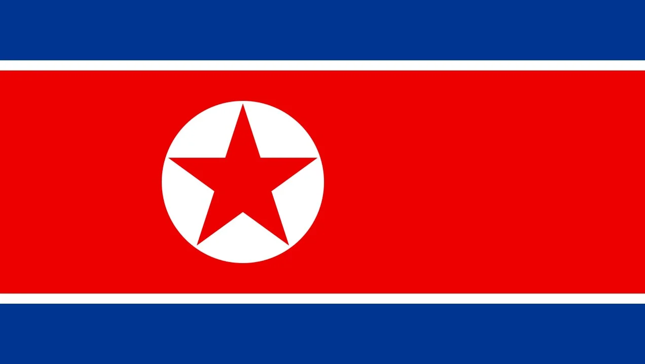 North Korean flag with red star in white circle on red background with blue stripes