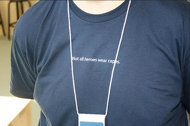 Apple Store employee navy t-shirt printed with 'Not all heroes wear capes'
