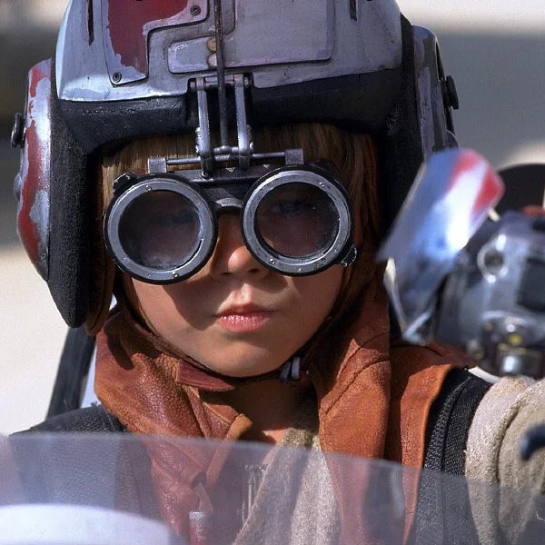 Now This Is Podracing — Young Anakin Skywalker in podracing helmet and goggles from Star Wars: The Phantom Menace