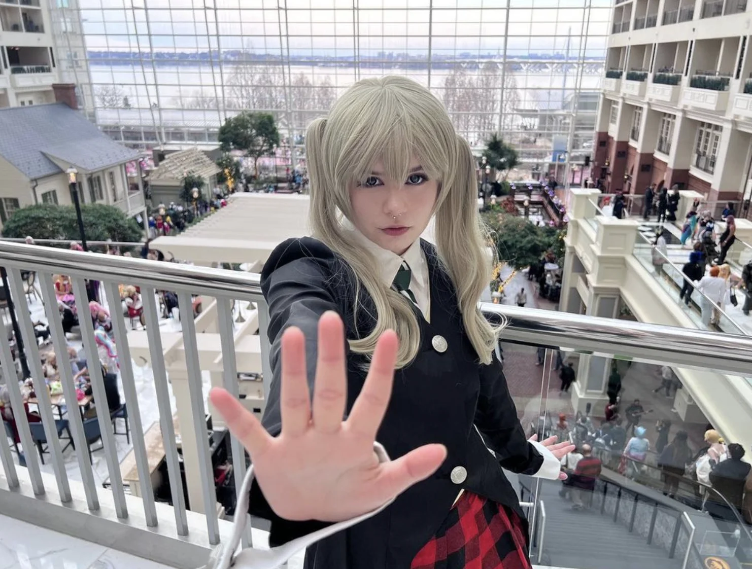 NyanNyanCosplay in blonde wig and black uniform cosplay at convention