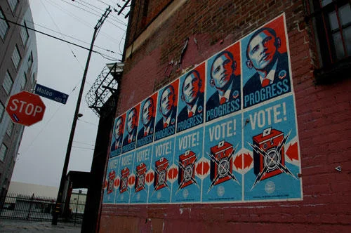 Obama Hope Posters — Street photography of brick building covered in Shepard Fairey Obama campaign posters.