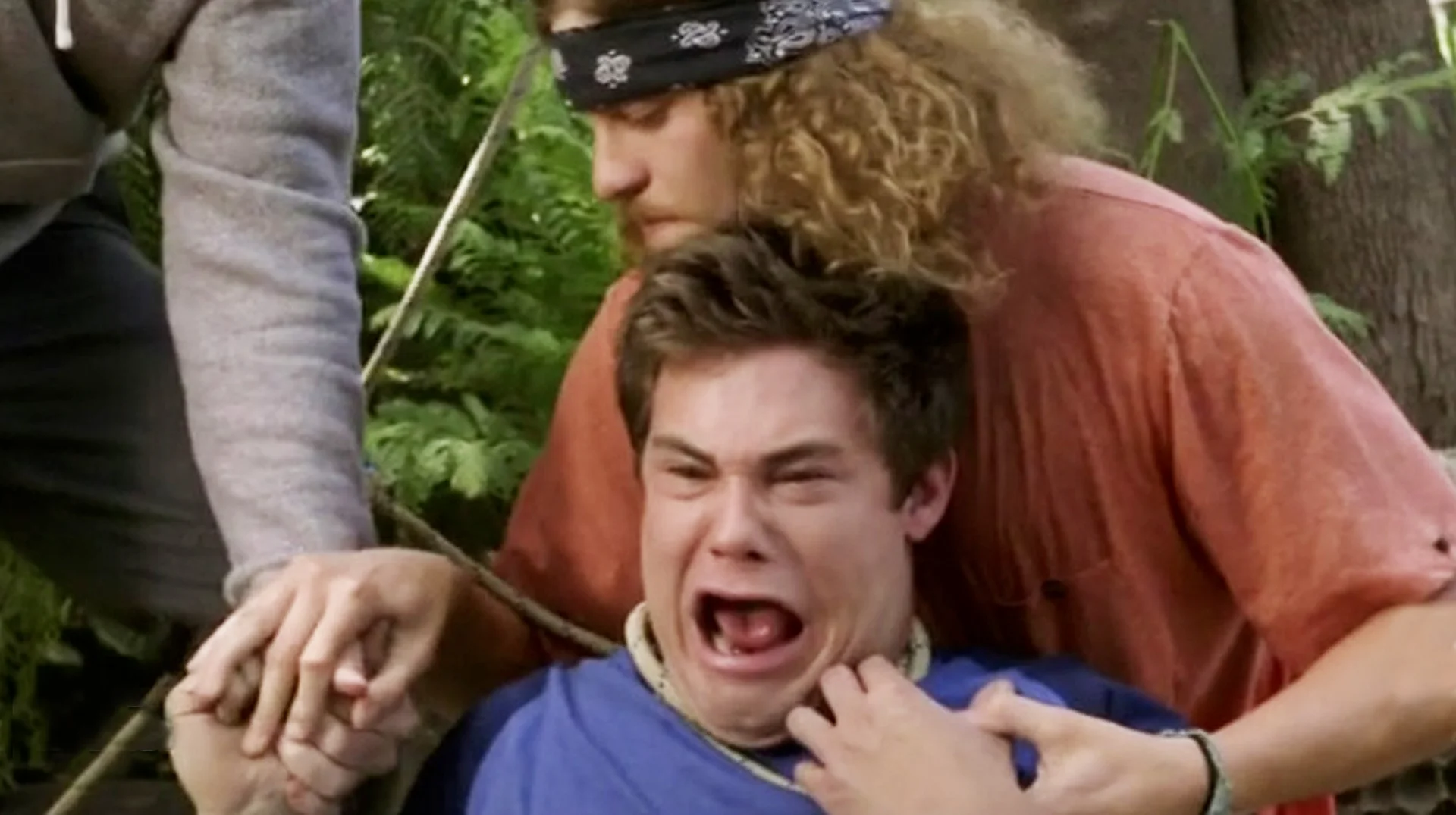 Oh My God I Almost Died Workaholics — Adam DeVine screaming with mouth wide open while Blake holds him from behind in a scene from Workaholics
