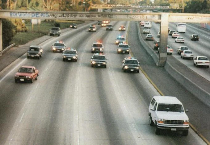 O.J. Simpson Murder Trial — White Ford Bronco followed by police cars on a Los Angeles freeway