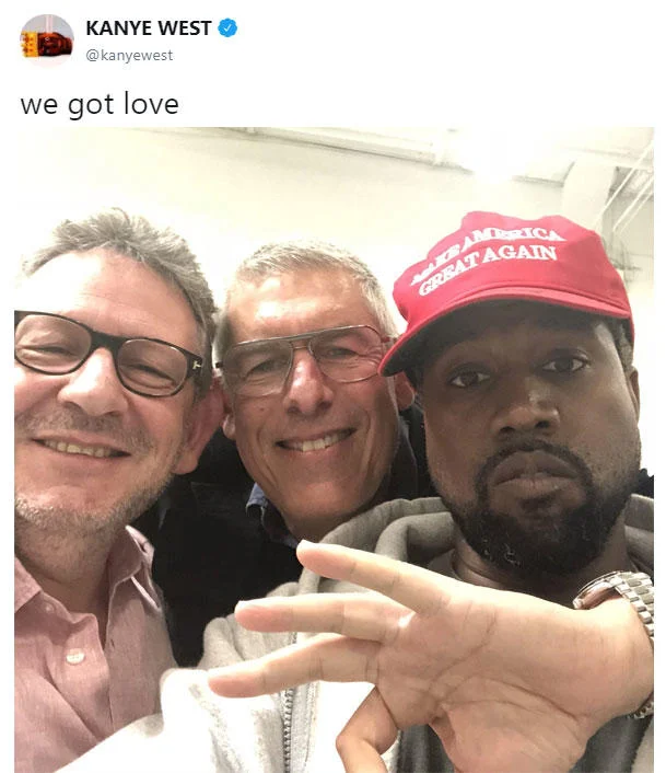 Ok Hand Sign — Kanye West Twitter post with three men, one making ok hand gesture and 'we got love.'