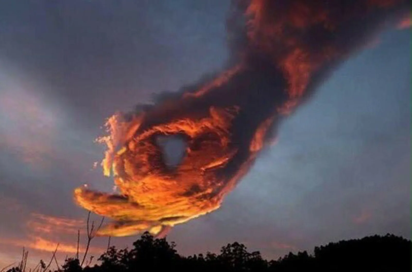 OK Symbol 👌 — Fiery orange sunset cloud shaped like a giant hand making the OK gesture against a dusky sky.