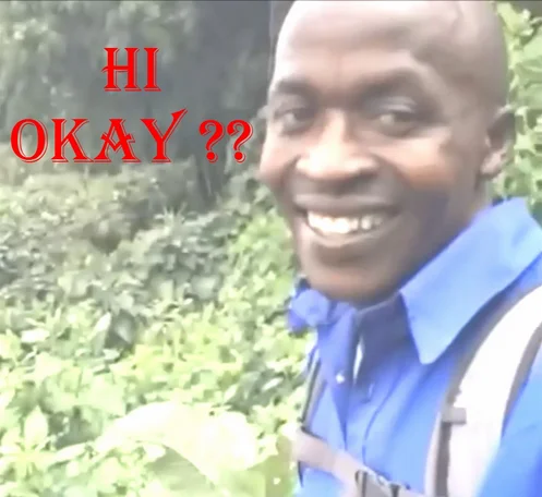 #OkayMovement — Smiling man in blue shirt outdoors with red 'HI OKAY ??' text overlay