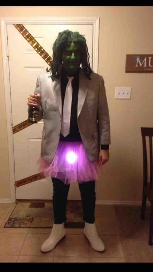 Halloween costume of Old Gregg with green face, seaweed wig, silver jacket, and light-up pink tutu