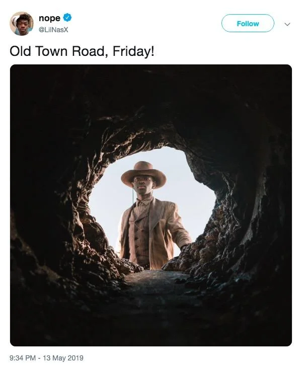 Promotional image with 'OLD TOWN ROAD' typography above moonlit horsemen silhouettes.