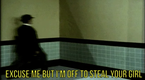 On My Way To Steal Yo Girl — Man in dark suit standing impossibly on hallway wall with 'EXCUSE ME OFF TO STEAL YOUR GIRL' text.