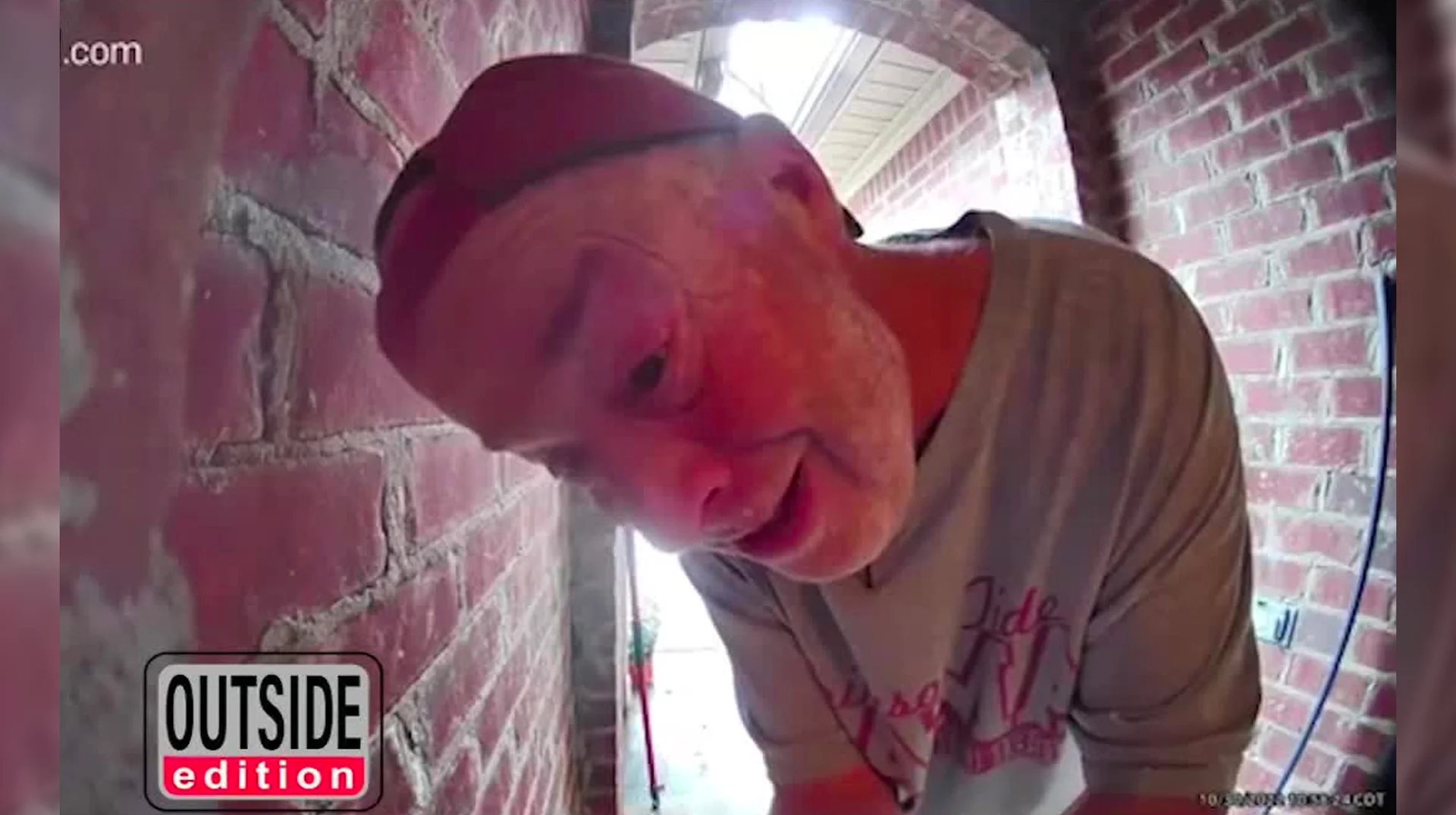 Open The Noor Open Na Noor — Doorbell camera view of an older man in a beanie leaning close to the lens inside a brick entryway, with an 'Outside Edition' logo