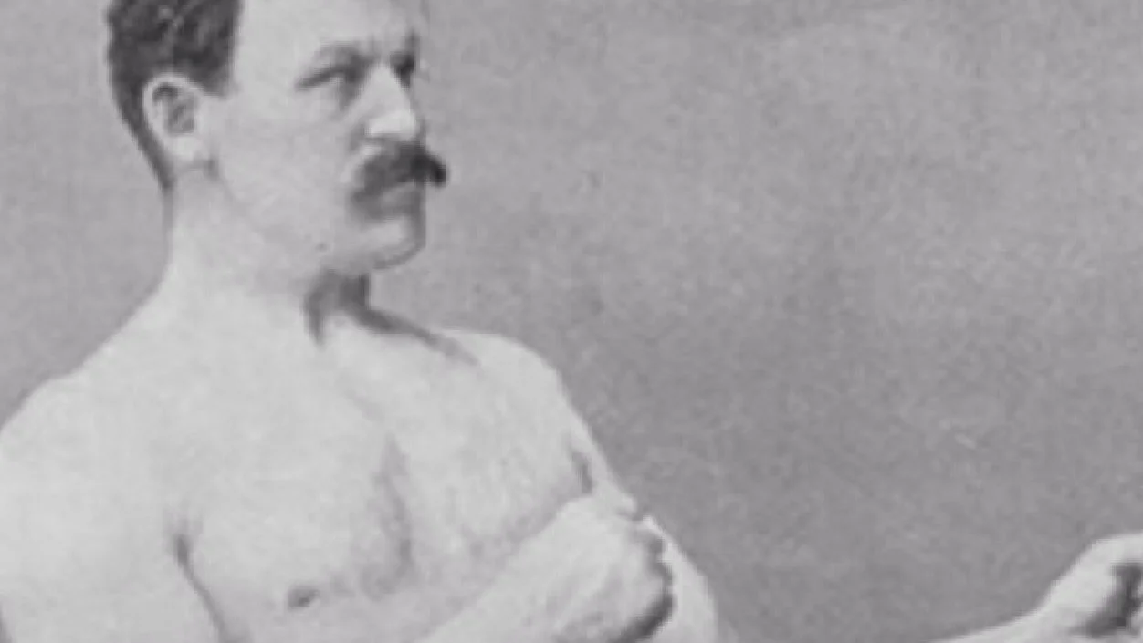Overly Manly Man — A pristine black and white photograph of the shirtless, mustachioed strongman in characteristic side pose without text overlay.