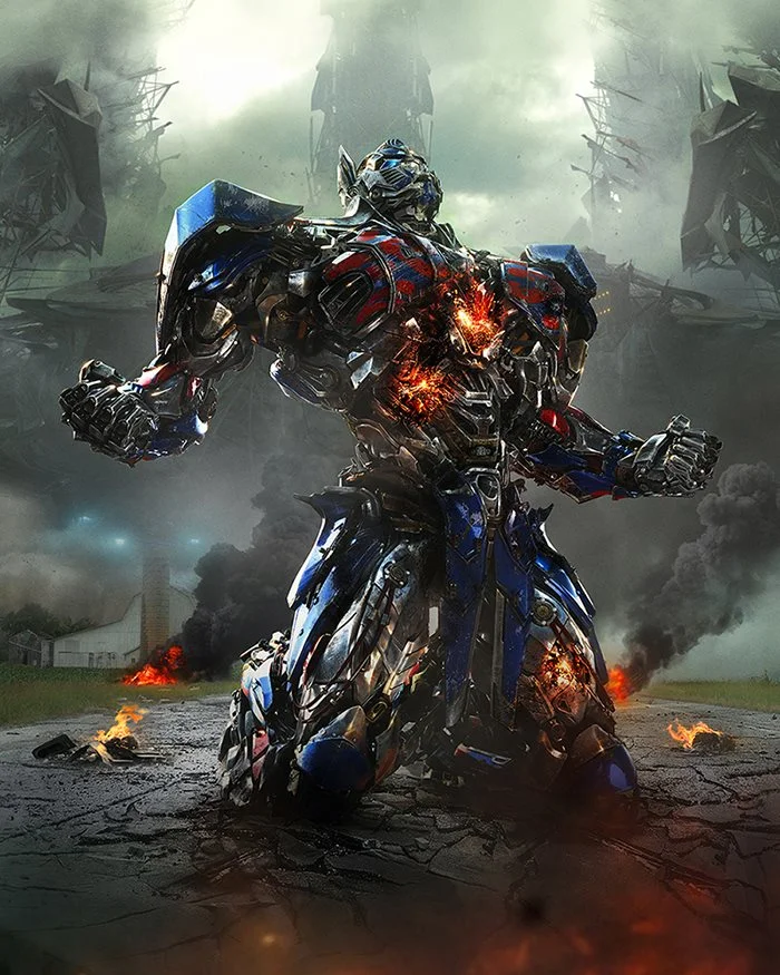 Overly Upset Optimus Prime — Battle-damaged Optimus Prime kneeling in a smoky, fiery wasteland