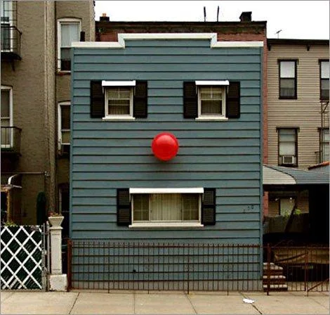 Pareidolia — Blue house with windows and red balloon arranged like a clown face