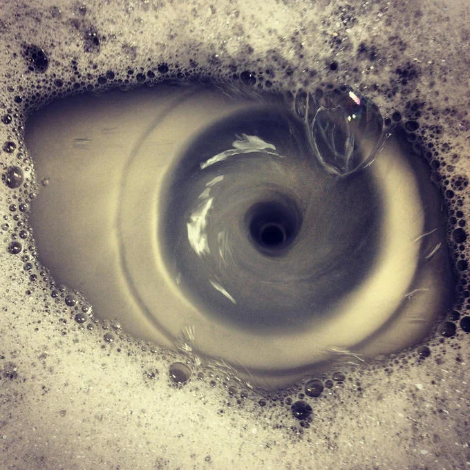 Pareidolia — Soapy sink drain resembling a giant eye