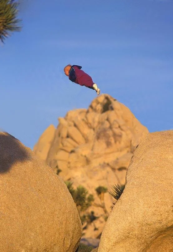 Parents Throwing Baby — Baby flying alone through the air over rocks