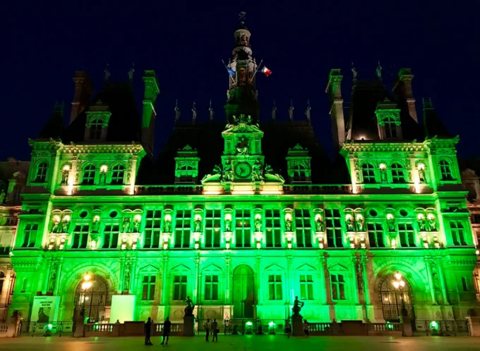 Paris Climate Agreement Withdrawal — Paris City Hall lit up in green at night in response to U.S. Paris Agreement withdrawal