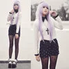 Two models showcasing pastel goth fashion: one in pastel pink and lavender with light hair, the other in dark clothing with vibrant blue hair.
