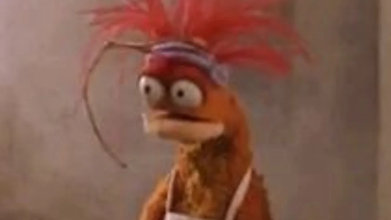 Pepe the King Prawn Muppet with wide eyes and red feathery head