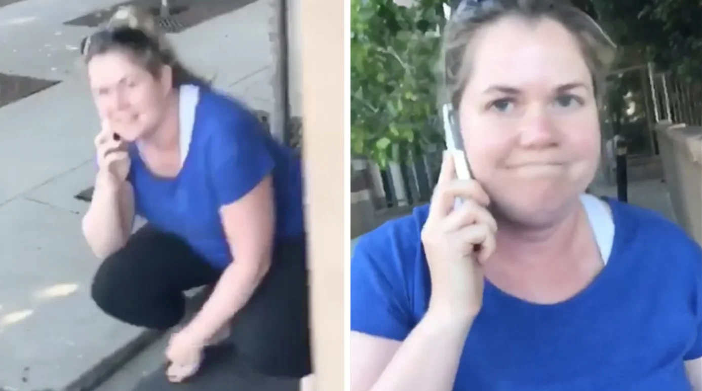 Permit Patty — Woman in blue shirt crouching behind a wall while using her cellphone on a city sidewalk.