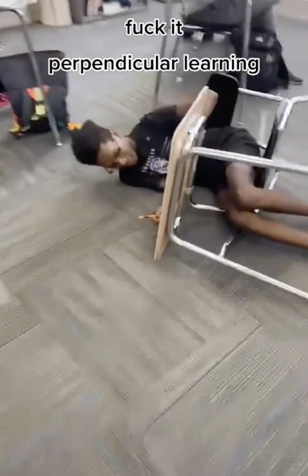 Perpendicular Fueling — Student lying on classroom floor beside an upright chair, with 'fuck it perpendicular learning' text.