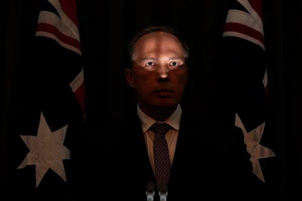 Peter Duttons Unflattering Face — The iconic viral photograph of Peter Dutton at a May 2016 press conference with harsh under-lighting dramatically