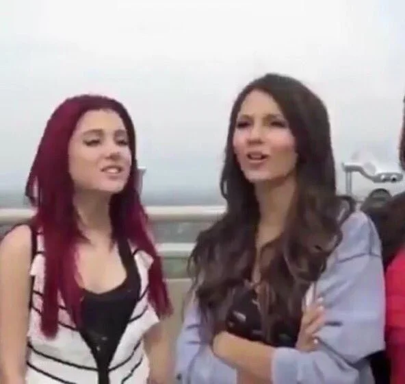 Petty Victoria Justice — Ariana Grande with red hair and Victoria Justice standing on a rooftop singing together.