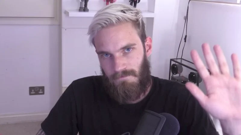 PewDiePie waving at the camera during a YouTube video recording