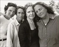 Photo A Day — A black and white portrait photograph of four people in casual clothing standing together.