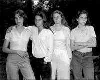 Photo A Day — A black and white portrait of four women standing together outdoors in a casual group pose.